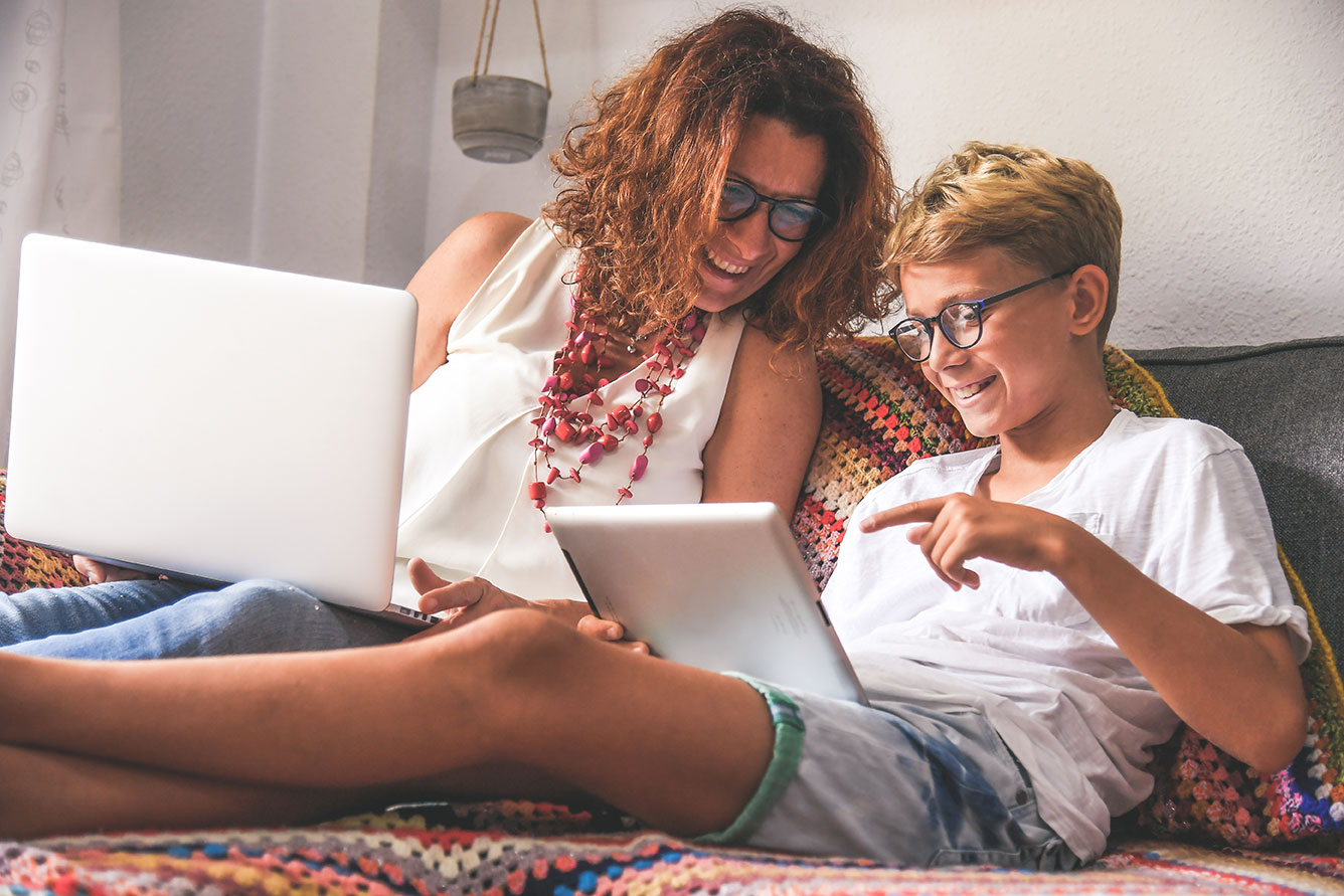 Child and mommy communicate and plays with tech device.